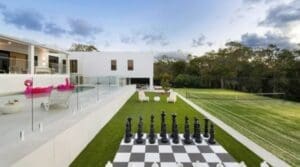 House with a tennis court and giant outdoor chess board